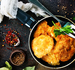 crumbed chicken in a pan