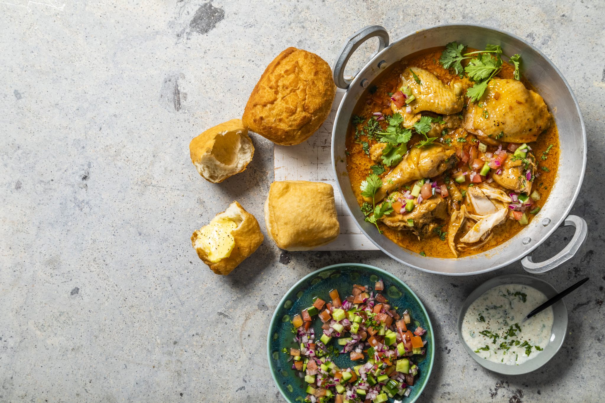 Butter chicken curry with vetkoek and sambals Astral Chicken